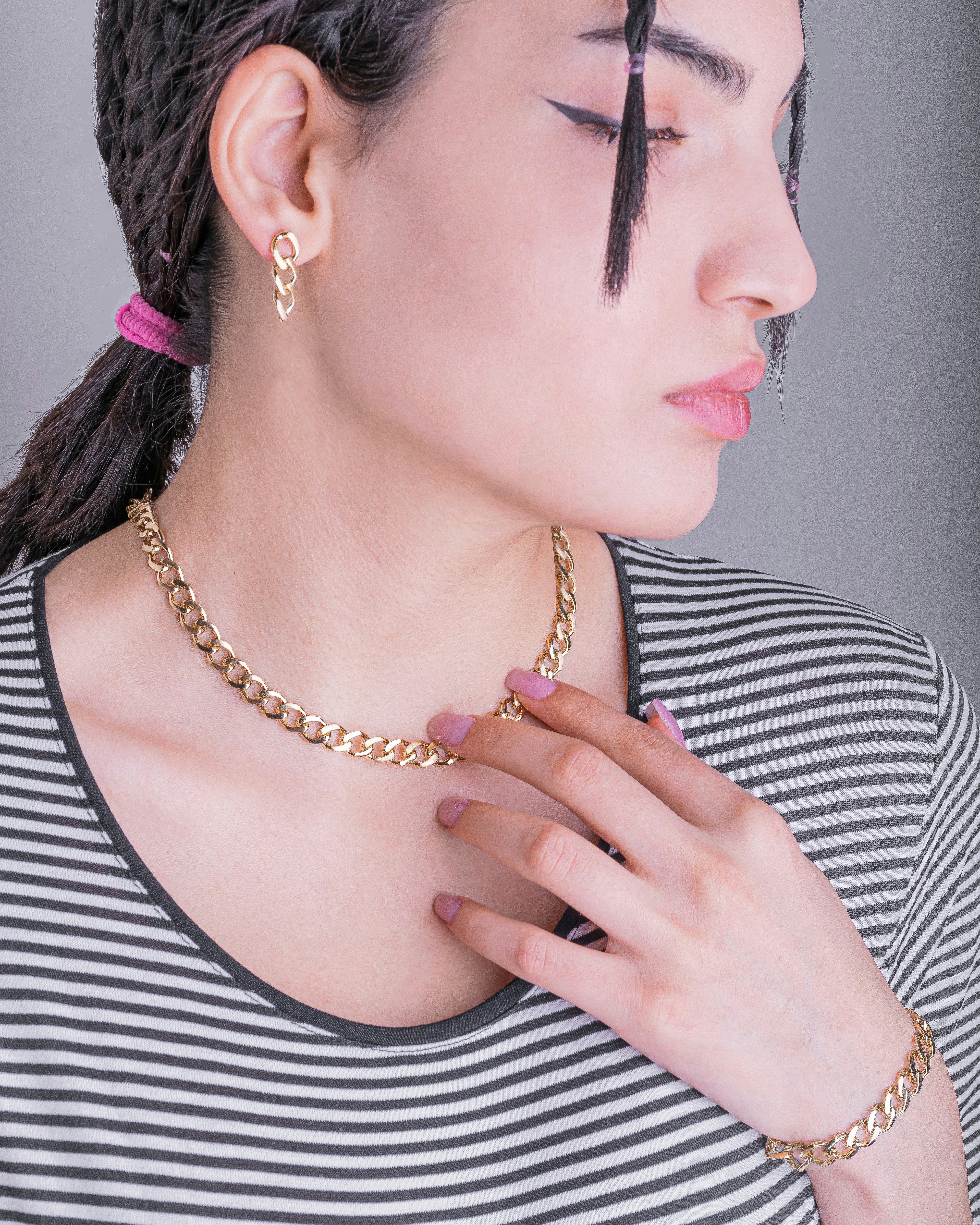 woman in black and white stripe shirt wearing silver necklace